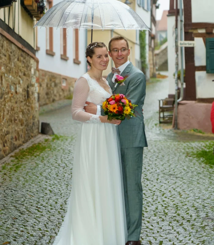 gluckliches-hochzeitspaar-unter-regenschirm